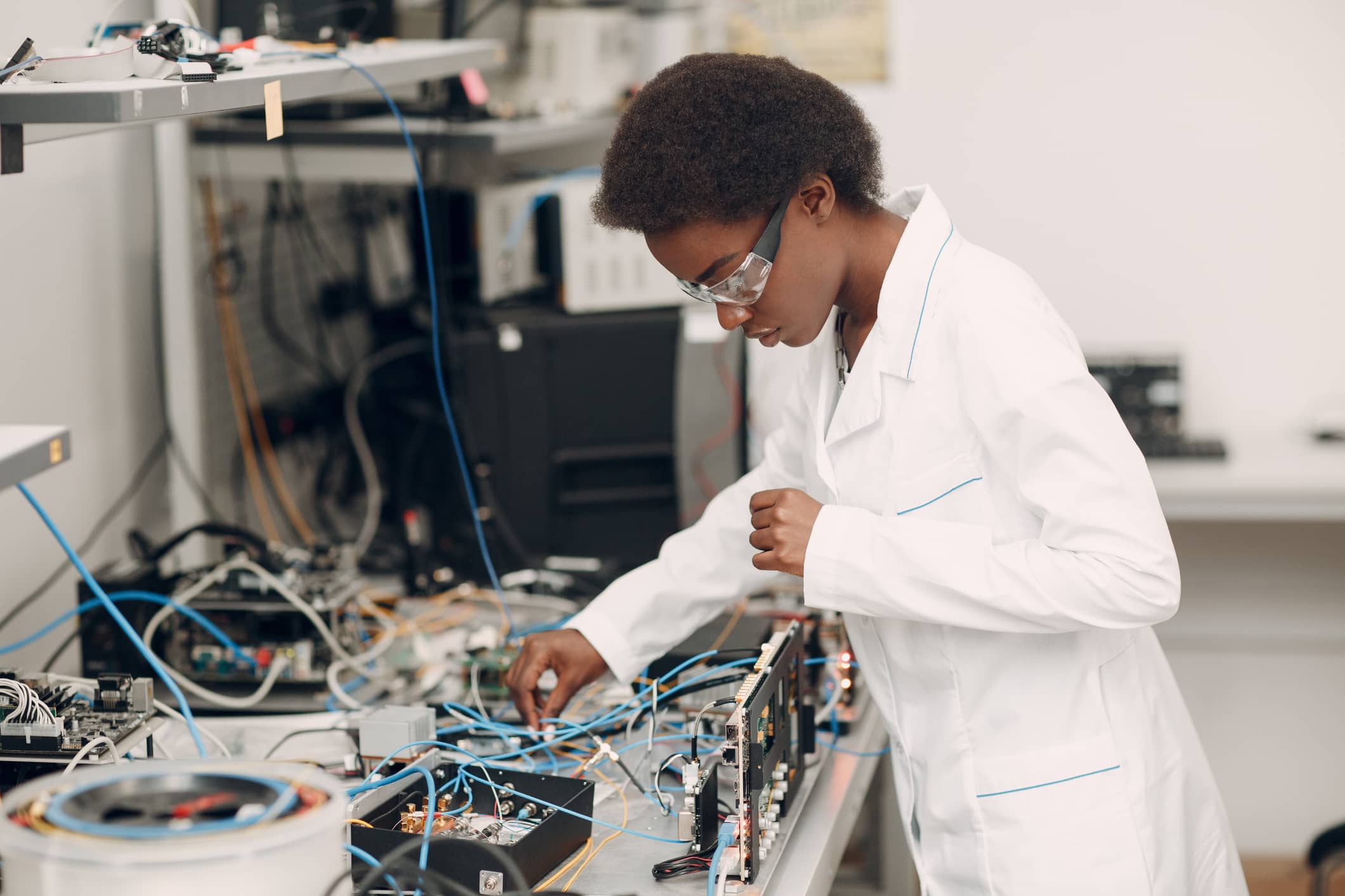 Scientist african american woman working in laboratory with electronic tech
